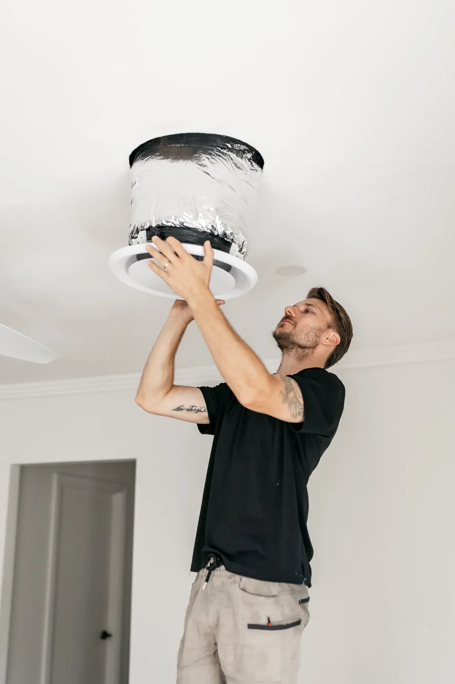 Moritz Electrical testing a photoelectric smoke alarm in a Brisbane home